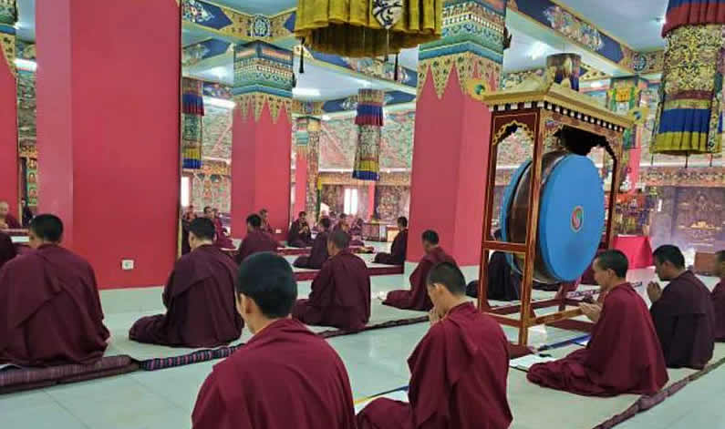 Mindrolling monks socially distance during prayers